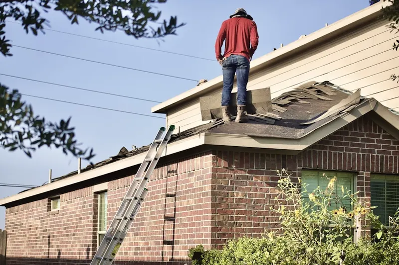 Professional roofer working on a residential roof in Sultan